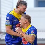 Matt Dufty (R) celebrates scoring one of his two tries for Warrington