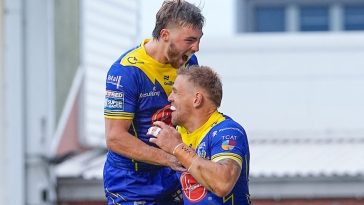 Matt Dufty (R) celebrates scoring one of his two tries for Warrington