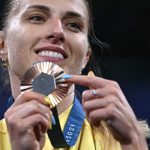 Bronze medallist Ukraine's Olga Kharlan celebrates on the podium during the medal ceremony for the women's sabre individual competition during the Paris 2024 Olympic Games at the Grand Palais in Paris, on July 29, 2024.