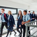 High school students walk through corridor