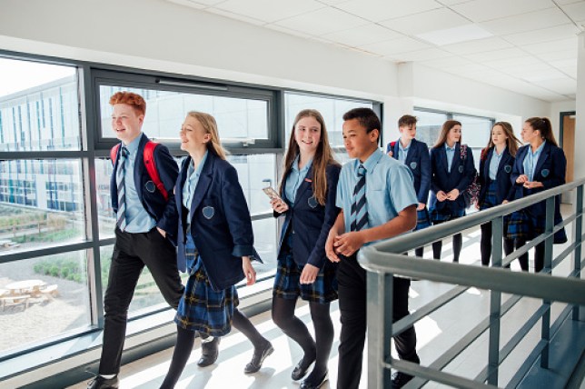 High school students walk through corridor