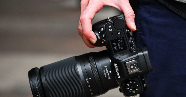 Hand at a person’s side holding a camera