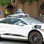 Waymo car driving on a street.