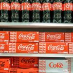 Bottles and cans of Coca-Cola on sale in a store