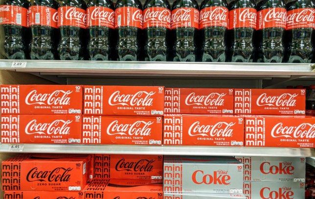 Bottles and cans of Coca-Cola on sale in a store