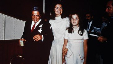 (Original Caption) Bearing traces of confetti, Mr. and Mrs. Aristotle Onassis, (Jackie Kennedy), are shown at their October 20th wedding on Onassis' private island. Caroline Kennedy, 10, stands next to her mother.