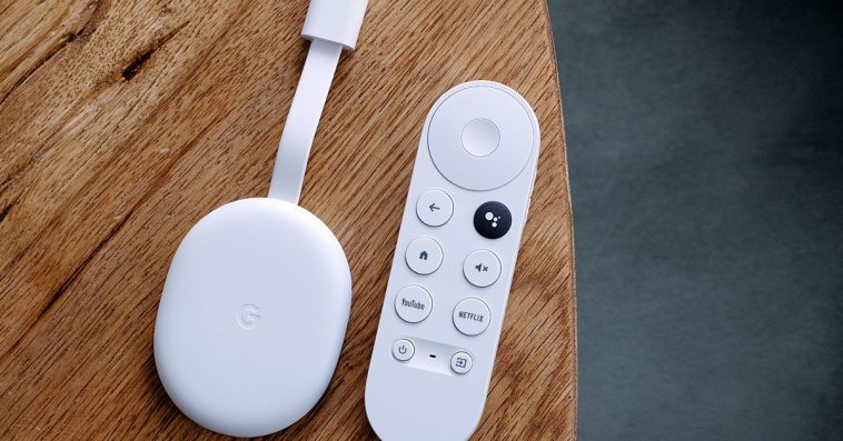 An overhead image of the Chromecast with Google TV HD and its remote on a wooden table.