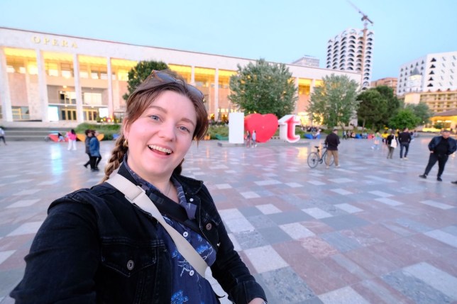 Chelsea Dickenson taking a selfie in a square in Tirana