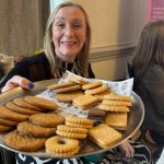 Julie Bale offering a plate of biscuits