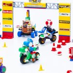 Several Lego Super Mario: Mario Kart vehicles posed against a starting gate.