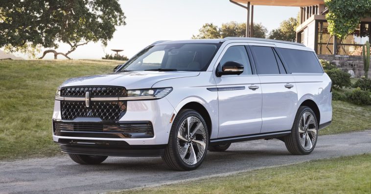 big white SUV in front of a modern building