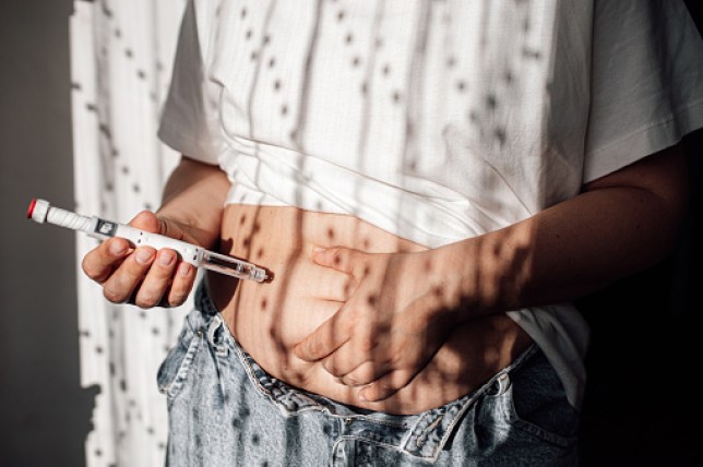 Injections for weight loss with Semaglutide. An obese woman gives a hormonal injection into the abdomen with a pen syringe.