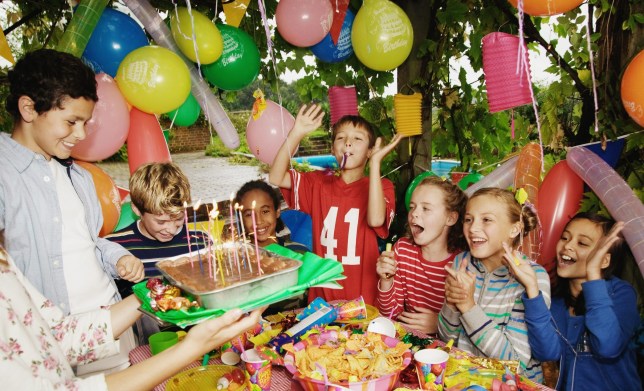 Group children (9-12) at birthday party outdoors