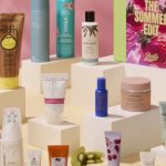 Beauty products sold at Boots arranged on various platforms, alongside the pink and green Summer Edit box