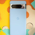 Photo of blue Google Pixel 8 Pro on a colorful play mat surrounded by building blocks