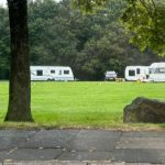 Travellers move to playing fields as group told to leave park just 3 miles away