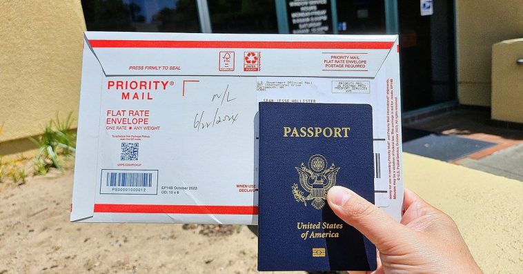 A photo of a person holding a US passport and an envelope.