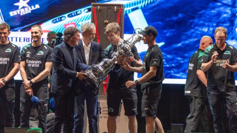 Pietro Beccari and Bernard Arnault present the Auld Mug to Emirates Team New Zealand, winners of the Louis Vuitton 37th America's Cup, at a ceremony in Barcelona.