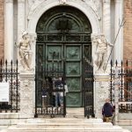 Restorers working on the Porta Magna in Venice