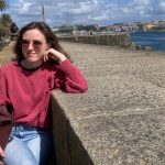 Sionna Hurley-O'Kelly pictured sitting by a concrete wall, resting her face on her hand.