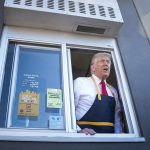 Donald Trump handing out food at a drive-thru window during a campaign stop at McDonald's on Oct. 20, 2024.