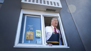 Donald Trump handing out food at a drive-thru window during a campaign stop at McDonald's on Oct. 20, 2024.