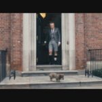 In a still from the film, Thom Browne and his dog Hector leave their home.