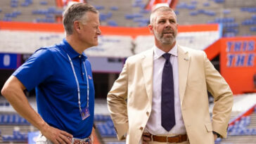 Sep 14, 2024; Gainesville, Florida, USA; Florida Gators athletic director Scott Stricklin (left) and head coach Billy Napier talk before a game against the Texas A&M Aggies at Ben Hill Griffin Stadium. Mandatory Credit: Matt Pendleton-Imagn Images