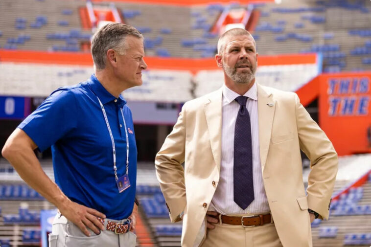 Sep 14, 2024; Gainesville, Florida, USA; Florida Gators athletic director Scott Stricklin (left) and head coach Billy Napier talk before a game against the Texas A&M Aggies at Ben Hill Griffin Stadium. Mandatory Credit: Matt Pendleton-Imagn Images