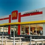 A McDonalds Drive-Thru in Cardiff, Wales in the 1990s, with white exterior, red detailing and the famous yellow 'M'