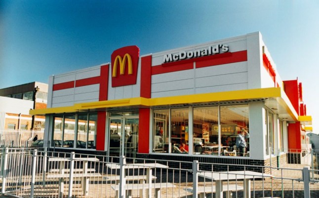 A McDonalds Drive-Thru in Cardiff, Wales in the 1990s, with white exterior, red detailing and the famous yellow 'M'