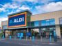 The frontage and brand logo of a branch of German discount retailer Aldi, taken in a local retail park on Wirral, UK on a sunny afternoon