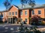 The exterior of Jurgen Klopp's former home just north of Liverpool in Merseyside. It is a large red brick home with a grey roof and columns around the door