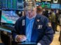 A trader wearing a Trump hat works on the floor of the New York Stock Exchange