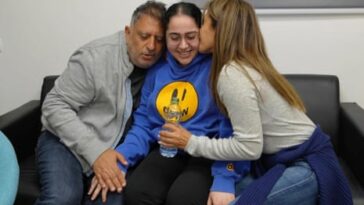 Released Israeli soldier, Liri Albag, embraces loved ones after being released, in an unknown location, on Saturday.