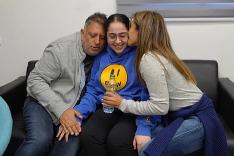 Released Israeli soldier, Liri Albag, embraces loved ones after being released, in an unknown location, on Saturday.