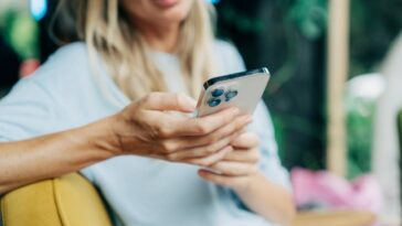 Close-up of a mobile phone in the hands of an unrecognizable person.