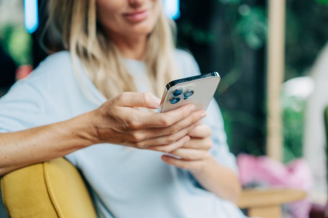 Close-up of a mobile phone in the hands of an unrecognizable person.