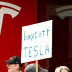 Demonstrators gather for a protest against Elon Musk and electric car maker Tesla.