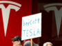 Demonstrators gather for a protest against Elon Musk and electric car maker Tesla.