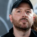 Fashion designer for Vetements, Demna Gvasalia talks to people at the end of his men and women's Spring/Summer 2019 collection fashion show, in Paris, on July 1, 2018. (Photo by GEOFFROY VAN DER HASSELT / AFP) (Photo by GEOFFROY VAN DER HASSELT/AFP via Getty Images)