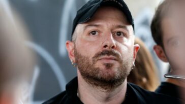 Fashion designer for Vetements, Demna Gvasalia talks to people at the end of his men and women's Spring/Summer 2019 collection fashion show, in Paris, on July 1, 2018. (Photo by GEOFFROY VAN DER HASSELT / AFP) (Photo by GEOFFROY VAN DER HASSELT/AFP via Getty Images)